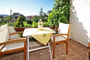 a table and chairs on a patio with a view at Villa Angela in Vourvourou