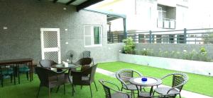 a group of tables and chairs on a patio at Knight Inn in Taitung City