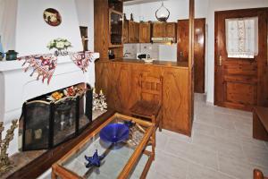 a living room with a table and a fireplace at Villa Angela in Vourvourou