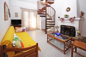 a living room with a couch and a fire place at Villa Angela in Vourvourou