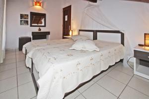 a bedroom with a large white bed in a room at Villa Angela in Vourvourou