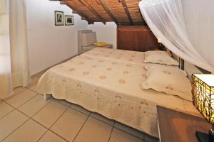 a bedroom with a bed with a mosquito net at Villa Angela in Vourvourou