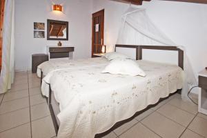 a bedroom with a large white bed in a room at Villa Angela in Vourvourou