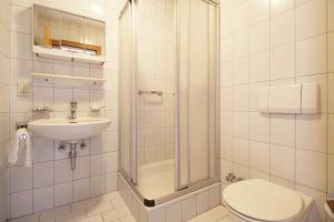 a bathroom with a sink and a toilet and a shower at Appartements Christophorus in Bad Hofgastein