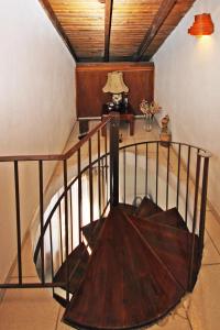 a spiral staircase in a room with a table and a lamp at Villa Angela in Vourvourou