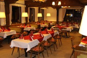 a dining room with red and white tables and chairs at Stubnerhof in Bad Gastein