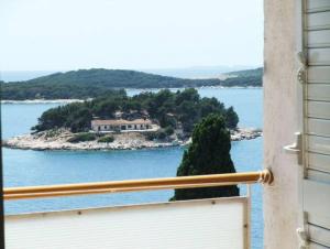 a view of a house on an island in the water at Rooms Vinka Tudor in Hvar
