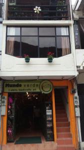 a store with two plants on the top of a building at Samay Apart in Baños