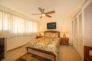 a bedroom with a bed and a ceiling fan at Beautiful 2 Bedroom Condo with Panoramic Ocean Views | Oceanfront in Kihei