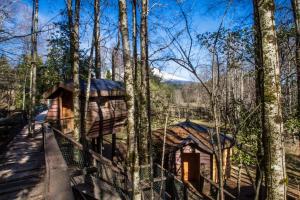 a cabin in the woods with a fence at Huilo Huilo Canopy Village in Huilo Huilo