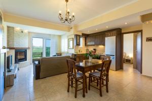 a kitchen and living room with a table and chairs at Stavroula Apartment near Panormo - Rethymno, Crete in Roumelí