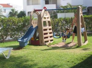 a couple of kids playing on a playground at Apartamentos Turisticos Silchoro in Albufeira