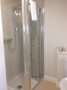 a shower with a glass door in a bathroom at A Castle View in Keiss +58 photos