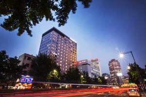 a city skyline with tall buildings and a street at night at Fraser Place Namdaemun Seoul in Seoul