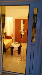 a room with a table and a bed and a mirror at Apartments Miljevic in Herceg-Novi