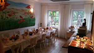 a dining room with tables with food on them at Gästehaus der Abtei Sayn in Bendorf
