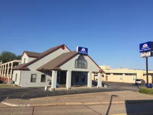 a white building with a sign in front of it at Americas Best Value Inn-Norman in Norman