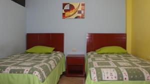 מיטה או מיטות בחדר ב-Hostal Aventura