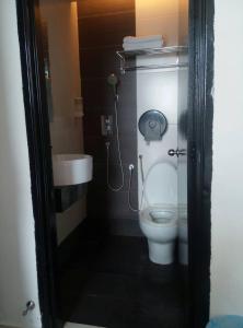 a bathroom with a toilet and a sink at Dream Hotel in Klang +10 photos
