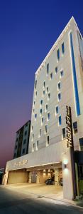 a large building with a sign on the side of it at Delight Hotel Jamsil in Seoul