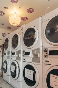 four washing machines are lined up in a room at Finlay Jack's Backpackers in Taupo