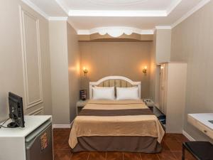 Postel nebo postele na pokoji v ubytování Urban Travellers Hotel