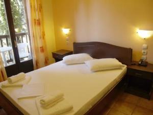 Postel nebo postele na pokoji v ubytování Hotel Figalia
