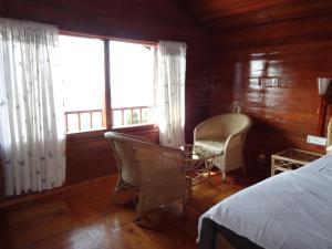 Postel nebo postele na pokoji v ubytování Surya Holidays Kodaikanal