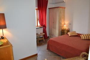 a bedroom with a bed with a red blanket at Monvillone in Cereseto