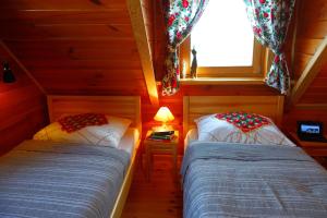 two beds in a room with a window at Agroturystyka Żabi Raj Serock - Pułtusk in Pokrzywnica +40 photos