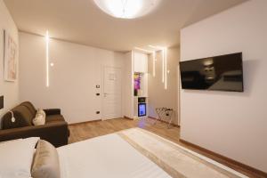 a living room with a couch and a flat screen tv at Etruska luxury Trastevere in Rome