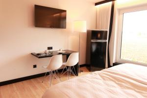 Een TV en/of entertainmentcenter bij LH Hotel by WMM Hotels
