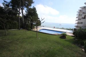 a yard with a swimming pool next to a building at For a Stay Sant Jordi in Salou +26 photos