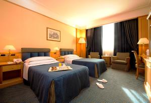 Postel nebo postele na pokoji v ubytování Grand Hotel Barone Di Sassj