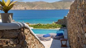 a swimming pool with a view of the ocean at Mykonos Panormos Villas in Mykonos