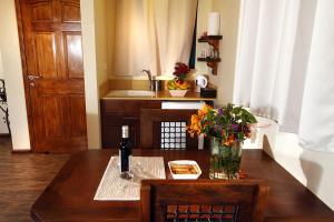 a dining room table with a vase of flowers on it at Cabin Eretz Ha-Kineret in Had Nes