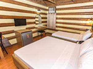 A bed or beds in a room at Urban Travellers Hotel