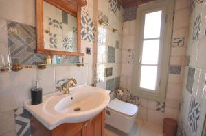 a bathroom with a sink and a toilet at Cunda Svila Otel - Adult Only in Ayvalık