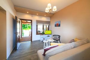 a living room with a couch and a table at Kissos Apartments in Vourvourou