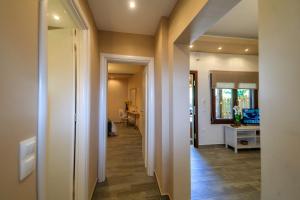 a hallway leading to a room with a desk and a table at Kissos Apartments in Vourvourou