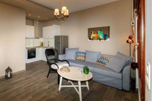a living room with a couch and a table at Kissos Apartments in Vourvourou