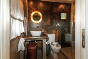 a bathroom with a sink and a toilet and a shower at Kissos Apartments in Vourvourou