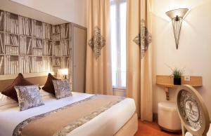 a hotel room with a bed and a book wall at Hotel Residence Foch in Paris