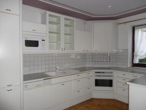 a white kitchen with a sink and a microwave at Ferienwohnung Walker in Oberdrauburg