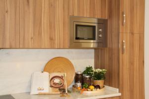 a kitchen counter with a microwave and a plate of food at 10 Boutique House in Alcochete