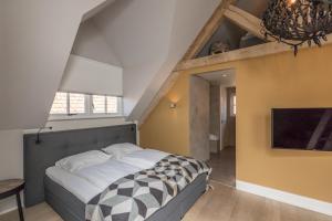 Postel nebo postele na pokoji v ubytování De Herberg Appartementen