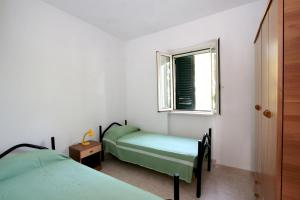 Giường trong phòng chung tại Residence Delfino