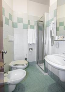 a bathroom with a toilet and a sink at Hotel Nember in Lido di Jesolo