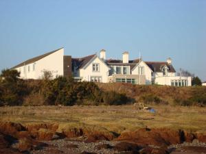 a house on top of a hill near the ocean at The Powfoot Hotel, Annan in Annan