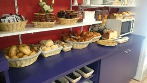 a counter with baskets of bread and other foods at Audotel in Carcassonne